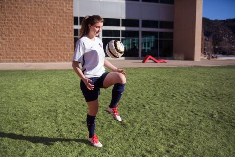 Girl playing soccer ball